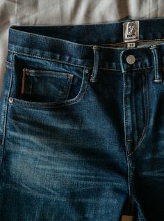 Slim fit Indigo Washed 14 oz 96% COTTON/4% POLYURETHANE Made in USA 4-Way stretch selvedge denim Model is 6'2" and wearing a size 32. Our premium denim is inspired by the classic vintage blue jean. Our Premium Japanese 4-Way Stretch Selvedge denim story starts in Japan where our fabric is developed at one of the oldest denim mills. We blend a unique 4 way stretch material with selvedge denim to create a specific amount of stretch and comfort you wouldn’t typically get with selvedge denim. This 3 Raw Jeans, Denim Pocket, The Pen, Selvedge Denim, Premium Denim, Blue Jean, Slim Jeans, Classic Vintage, Denim Fabric