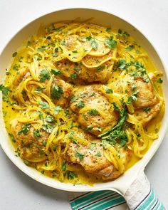 chicken with noodles and parsley in a skillet