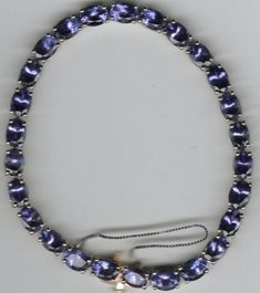 This stunning bracelet features 26 natural Tanzanite gemstones, each with a brilliance cut grade and an oval shape. The bracelet is made of 925 sterling silver and has a box chain type with a braclet clasp and security chain closure. The item measures 8.5 inches in length and has a total carat weight of 23.54ct. The bracelet is a beauty and art piece that will make a great addition to any jewelry collection. It is nickel-free and comes with EGL USA certification. The seller provides a warranty and the bracelet is customizable, but not signed. This retro-style bracelet has a timeless appeal and is perfect for any occasion. Tanzanite Bracelet, Bar Setting, Violet Color, Tanzanite Gemstone, Natural Tanzanite, Box Chain, Earrings Set, Matching Earrings, Sterling Silver Bracelets