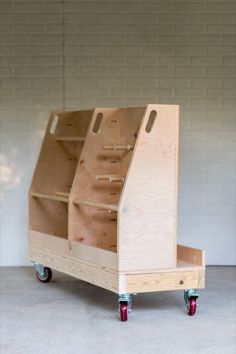 a wooden cart with three shelves on wheels