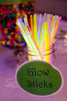 glow sticks in a mason jar on a table