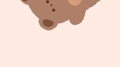 a brown teddy bear sitting on top of a pink wall