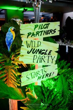 green plants with signs on them that read pilot partners wild jungle party starts here