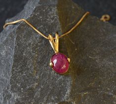 Gold Ruby Pendant set with a Natural Ruby in a natural red color & translucent clarity, at 10x8mm, weighing 3 Carats, sourced from Burma. Dainty Red Pendant design made of Gold Vermeil ☞ thickest 18k Gold Plating on top of Solid 925 Sterling Silver ☞ made to last. Click here for ☞ Matching Ring Matching Earrings - please ask me Details:♥ Natural Ruby sourced from Burma♥ Ruby: 10x8mm, 3 Ct total, Oval Cabochon cut♥ Pendant Height 18mm, Width 10mm♥ Free Complimentary Chain♥ 18k Gold Vermeil❀ Each Yellow Gold Ruby Gemstones, Round Ruby Gemstones In Yellow Gold, Elegant Red Polished Gemstones, Red Ruby Cabochon Necklace, Elegant Ruby Gemstones As Gift, Elegant Red Cabochon Gemstones, Elegant Red Gemstones For Gift, Elegant Red Gemstones As A Gift, Ruby Gemstones For Gifts In Fine Jewelry Style