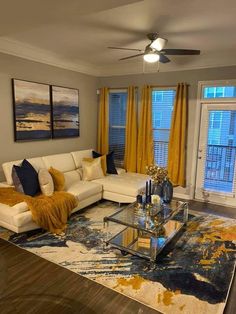 a living room filled with furniture and yellow drapes