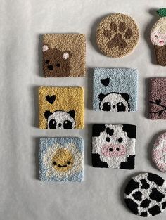 nine small coasters with different animal designs on them, all made out of felt