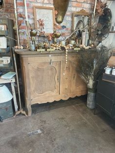 an old fashioned dresser is in the corner of a room with other items on it