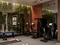 an indoor gym with exercise equipment and plants growing on the wall behind it, as well as yoga mats