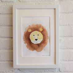 a painting of a lion is hanging on the wall next to a white brick wall