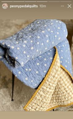 a blue and white blanket sitting on top of a chair