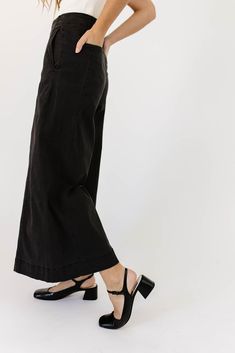 a pair of black wide-leg pants that are sooo good, you’ll never want to take them off. the high-rise + fitted waistline gives it “business casual” charisma, while the flowy loose legs keep things real + relaxed. full of versatility, you can dress them up or down for any occasion. black // wide leg, high waisted, one button zip fly, belt loops, pockets paired with our matilda mesh top + lover denim vest model is 5'8" + wearing a small measurements are approximate + taken while laying flat small : Chic Wide Leg Culottes For Business Casual, Casual Wide-leg Culottes For Business Casual, Chic Black Culottes For Spring, Casual Wide Leg Culottes For Business Casual, Casual Business Wide Leg Culottes, Sleek Wide Leg Pants For Spring Workwear, Chic Wide Leg Workwear Pants, Versatile Wide Leg Spring Dress Pants, Spring Wide Leg Versatile Dress Pants