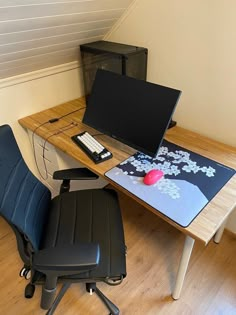 a desk with a chair and computer monitor on it