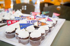 cupcakes with white frosting and flags on them