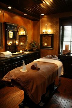 a spa room with two massage tables and candles