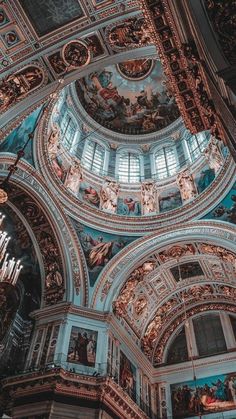 the inside of an ornate building with paintings on it's walls and ceilinging