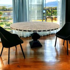 a dining room table with chairs and a vase on the floor in front of it