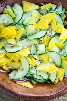 cucumber and onion salad in a wooden bowl