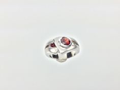 "Hi everyone, just wanted to let you know we are open and shipping daily. Silver Garnet Ring // Matte Platinum (Rhodium) Finish // Handmade // Modern Design // Size 7 Beautifully crafted \"one of a kind\" contemporary Sterling Silver ring with genuine Garnet center stone. This garnet is of a deep ruby red color. The silver ring is finished with Rhodium so it will not tarnish. This fine jewelry quality ring is perfect for work and formal occasions to match your sterling, white gold or platinum je Modern Ruby Promise Ring With Polished Finish, Modern Sterling Silver Birthstone Ring For Formal Events, Modern Sterling Silver Birthstone Ring For Formal Occasions, Contemporary Round Rings For Anniversary, Modern Sterling Silver Rings With Round Cut, Modern Sterling Silver Ruby Wedding Ring, Modern White Gold Ruby Ring For Anniversary, Modern Silver Ruby Ring With Polished Finish, Modern Silver Ruby Ring For Formal Occasions