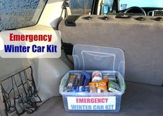 an emergency car kit sits in the back seat of a vehicle with its door open