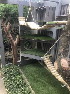 an indoor play area with grass and swings