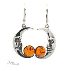 Celebrate the beauty of the moon with these classic crescent moon earrings decorated with a round cognac Baltic amber stone that shines in the sun, a handsome reflection of the moon's own nighttime glow. Amber is a powerful healer and cleanser of the body. When paired with the symbology of the moon, amber is thought to bring calm dreams, a sense of empowerment, self-confidence, and the ability to transform dreams into reality. A perfect pair of lunar earrings for the lengthening Fall nights! Pai Mystical Sun And Moon Earrings As Gift, Spiritual Crescent Nickel-free Earrings, Elegant Moon Shaped Earrings With Sun And Moon Design, Spiritual Crescent Earrings As Gift, Spiritual Crescent Earrings For Gift, Symbolic Round Earrings With Moon Charm, Sun And Moon Design Spiritual Earrings As Gift, Mystical Crescent Earrings For Gift, Symbolic Crescent Moon Charm Earrings