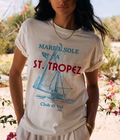 Set sail in style with our "St. Tropez Sailing Club" T-Shirt, inspired by the chic and elegant vibes of the French Riviera. This vintage nautical design features a stylized logo of the renowned St. Tropez Sailing Club, capturing the charm and sophistication of this exclusive destination. Crafted from premium, soft cotton, this tee ensures exceptional comfort while showcasing a timeless and fashionable look. Ideal for sea lovers, yachting enthusiasts, and anyone who adores the Tropezian lifestyle, this T-shirt is a must-have for your summer wardrobe. Wear it to add a touch of coastal elegance to any outfit! Details: Material: 100% Cotton Sizes: XS, S, M, L, XL, XXL Colors; White, Natural, Soft Pink Care: Machine wash cold, tumble dry low Designed with love and crafted for comfort ❤️ Pair it French Riviera Design, Summer Graphic Print Crew T-shirt, Nautical Cotton T-shirt For Summer, White Nautical Tops For Vacation, White Nautical Short Sleeve Tops, Graphic Print Crew Neck T-shirt For Sailing, Nautical Short Sleeve Beach Top, Nautical Graphic Print Tops For Sailing, Nautical White T-shirt With Graphic Print