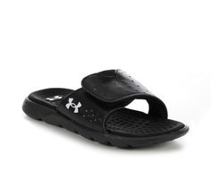 a pair of black sandals with white logo on the bottom and one foot in the middle