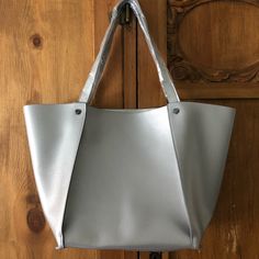 This Neiman Marcus Bag Is The Perfect Size And Color. Elegant And Fun, Goes With Everything. New, No Tags, Still Has The Plastic Protective Wrap On The Handles. Man Made Material, Not Leather. Large Shoulder Bag With Handles For Errands, Silver Rectangular Shopping Bag, Silver Tote Shoulder Bag For On-the-go, Everyday Rectangular Shoulder Bag With Silver-tone Hardware, Shopping Bucket Bag With Silver-tone Hardware, Silver Tote Bag For Errands, Silver Satchel For Everyday Use, Gray Large Capacity Bags For Shopping, Large Capacity Shopping Bags