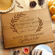 a wooden cutting board with the words happy retirement written in cursive writing on it