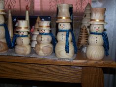 a group of wooden snowmen sitting on top of a table