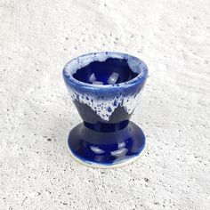 a blue and white cup sitting on top of a saucer