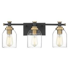 three light bathroom fixture with clear glass shades and gold accents on an old - fashioned black finish