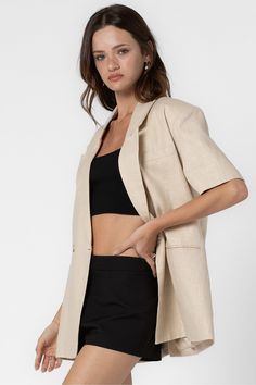 Half length sleeves Classic lapel collar One-button closure Single breast pocket Back vent Lined Fits oversized. Model measurements: Height 5'9", Bust 30.5", Waist 23.5", Hips 33.5" | Wearing a S/M. 85% Linen, 15% Cotton | Lining : 100% Polyester Classic Relaxed Fit Collared Blazer, Classic Collared Blazer With Relaxed Fit, Collared Blazer With Double Button For Business Casual, Relaxed Fit Collared Blazer With Buttons, Classic Short Sleeve Spring Blazer, Collared Single Button Outerwear For Business Casual, Classic Collared Relaxed Fit Blazer, Spring Office Blazer With Collar, Short Sleeve Blazer For Spring Office Wear