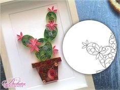 an image of a cactus in a pot with flowers on it and a paper plate next to it