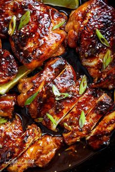 chicken wings with sauce and green onions in a skillet, ready to be cooked