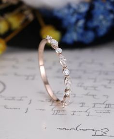 a diamond ring sitting on top of a piece of paper