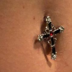 a close up of a person's belly with a cross on the back of it