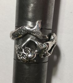 My SMALL COIL MERMAID RING is adorable and very detailed. Adjustable and coils around the finger. With the upper body of a woman, long flowing hair, and a beautiful bewitching voice. For the Mermaid or Siren Lover. Hand carved in Wax, Cast into Sterling Silver. On Sale! Adjustable, Available in Sizes 4.0 -7.5 Sterling Silver 5.5 - 6.0 gm. Indicate Size desired Adjustable Silver Rings With Ocean-inspired Style, Adjustable Silver Ocean-inspired Rings, Womens Rings, Mermaid Ring, Mermaid Jewelry, Ring Sizes, 925 Silver Rings, Adjustable Rings, Women Rings