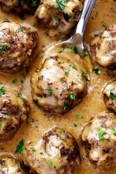 meatballs with gravy and parsley in a skillet, ready to be eaten