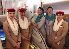 four women in airline uniforms standing next to each other