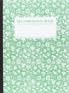 a green and white book with flowers on the cover, in front of a black background