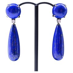 Lapis Lazuli Diamonds earrings in 18-carat black gold. This pair of earrings consists of a cabochon-shaped lapis lazuli mounted on an articulated 18-carat black gold hanger. A brilliant-cut diamond separates it from the second, candelabra-shaped lapis lazuli part. Length: 1.5 inch Depth: 0.19 inch Width: 0,5 inch Total weight of the pair: 15.4 grams. Weight of 18-carat gold: 3.12 grams These earrings are easy to fasten thanks to the pram clasps, which make them simple and secure to use. The clasp is made of 18-carat gold. This pair of earrings can be worn for all occasions, and will dress up an evening outfit as well as an everyday outfit. This bright blue will go perfectly with all accessories and outfits. In perfect condition. Gold Hangers, Earrings Diamonds, Diamonds Earrings, Evening Outfit, Evening Outfits, Diamond Gold, Brilliant Cut Diamond, Bright Blue, Lapis Lazuli