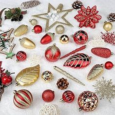 a collection of christmas ornaments on snow covered ground