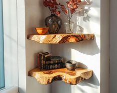 two wooden shelves with books and vases on them