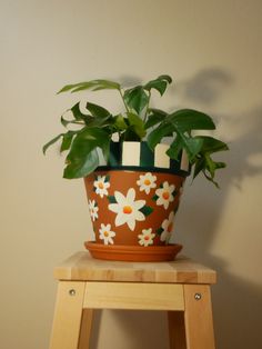 a potted plant sitting on top of a wooden stool