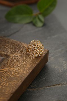 This ring is a beautiful floral design. This contemporary cocktail ring is encrusted with kundan. Ring - Adjustable Style Tip - Style this with classic banarasi sarees, lehengas or indo western wear dresses. A perfect match with almost any traditional classic. A very chic and contemporary ring that is a favorite for all ages. Handcrafted in Jammu and Kashmir Paisley Pop travels the depths of India to learn techniques and crafts from deep down the local markets and villages. We give utmost import Round Tilla Rings For Wedding, Wedding Toe Ring With Intricate Design, Tilla Rings For Wedding And Festivals, Meenakari Toe Ring For Wedding, Wedding Toe Ring With Meenakari, Wedding Toe Ring With Meenakari Detail, Fusion Style Wedding Ring With Intricate Design, Fusion Style Wedding Rings For Festive Occasions, Fusion Style Wedding Rings For Festive Season