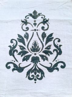 an embroidered white cloth with black designs on it