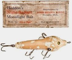 an old fashioned fishing lure next to a sign for night - ragt moonlight bait