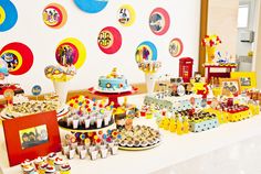 a table topped with lots of cakes and cupcakes