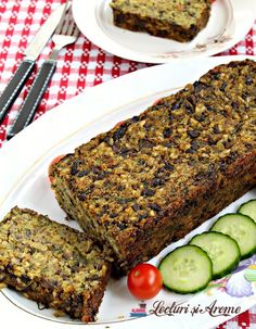 two plates with slices of bread and cucumbers next to each other on a checkered table cloth